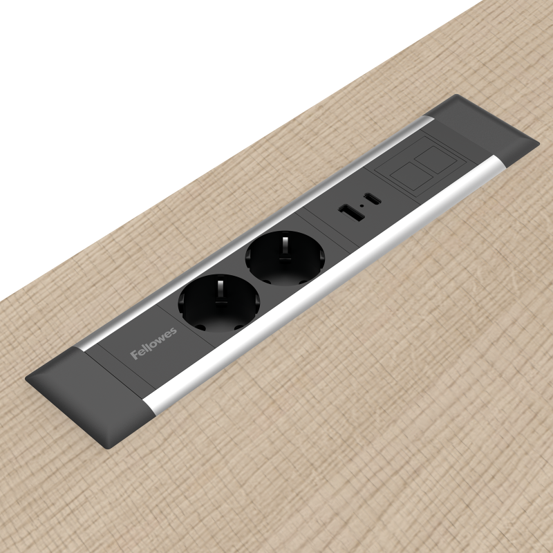 Lange rechthoekige Desk Insert die vlak in bureaus en andere meubels past. De unit heeft twee 230V poorten, een USB-poort en een modulaire keystone poort. De behuizing is zwart met een zilveren rand.